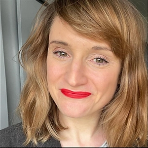 Sales executive Laura Taylor-Williams, with wavy fair hair and red lipstick, smiling.