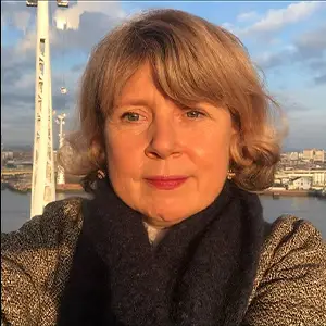Filmmaker Victoria Mapplebeck, with blonde hair and a tweed jacket, in front of the London Eye.